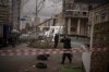 Police officers inspect area after an apparent Russian strike in Kyiv Ukraine, Thursday, Feb. 24, 2022. Russian President Vladimir Putin on Thursday announced a military operation in Ukraine and warned other countries that any attempt to interfere with the Russian action would lead to 