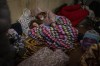 People rest in the Kyiv subway, using it as a bomb shelter in Kyiv, Ukraine, Thursday, Feb. 24, 2022. Russia has launched a full-scale invasion of Ukraine, unleashing airstrikes on cities and military bases and sending troops and tanks from multiple directions in a move that could rewrite the world's geopolitical landscape. THE CANADIAN PRESS/AP-Emilio Morenatti