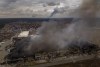 A factory and a store are burning after been bombarded in Irpin, in the outskirts of Kyiv, Ukraine, Sunday, March 6, 2022. (AP Photo/Emilio Morenatti)