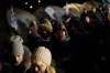 Refugees fleeing war in neighboring Ukraine walk past tents after crossing to Medyka, Poland, Wednesday, March 9, 2022. (AP Photo/Daniel Cole)