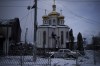 FILE - A destroyed car is parked in front of a damaged church in Irpin, on the outskirts of Kyiv, Ukraine, Tuesday, March 8, 2022. (AP Photo/Felipe Dana)