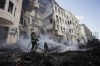 Firefighters extinguish an apartment house after a Russian rocket attack in Kharkiv, Ukraine's second-largest city, Ukraine, Monday, March 14, 2022. A new poll suggests nearly three quarters of Canadians believe NATO allies should prepare for military intervention as Russian aggression escalates in Ukraine, even as half hold out hope for a diplomatic resolution. THE CANADIAN PRESS/AP-Pavel Dorogoy