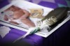 A proposed class action has been filed against Manitoba by a woman who had her newborn removed by police and social workers in a video broadcast live on social media. An eagle feather and a baby hospital ID bracelet sit on a photo of a newborn baby during a press conference in support of the mother who's newborn baby was seized from hospital by Manitoba's Child and Family Services, in Winnipeg on Friday, January 11, 2019.&nbsp; THE CANADIAN PRESS/John Woods