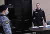 Russian opposition leader Alexei Navalny, right, is seen via a video link provided by the Russian Federal Penitentiary Service, standing during a court session in Pokrov, Vladimir region, about 100 kilometers (62 miles) east of Moscow, Russia, Tuesday, March 22, 2022. The Russian authorities are seeking a 13-year prison sentence for opposition leader Alexei Navalny in a trial Kremlin critics see as an attempt to keep President Vladimir Putin's most ardent foe in prison for as long as possible. (AP Photo/Alexander Zemlianichenko)