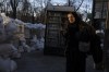 An elderly woman walks pass concrete blocks topped with sandbags at a street in Odesa, southern Ukraine, on Tuesday, March 22, 2022. (AP Photo/Petros Giannakouris)