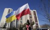 FILE - A man waves the Ukrainian and Polish flag during a demonstration in front of a building housing Russian diplomats in Warsaw, Poland, Sunday, March 13, 2022. Poland’s Internal Security Agency says it has identified 45 Russian secret service officers and their associates who have enjoyed diplomatic status in Poland. The agency is asking the Foreign Ministry to expel the Russians who were described as a danger to Poland’s security. The agency also said Wednesday, March 23, 2022 that it detained a Polish citizen on suspicions of espionage for the Russian secret services. (AP Photo/Czarek Sokolowski, File)