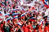 People wave Russian national flags as they gather to attend the concert marking the eighth anniversary of the referendum on the state status of Crimea and Sevastopol and its reunification with Russia, in Moscow, Russia, Friday, March 18, 2022. (Ramil Sitdikov/Sputnik Host Photo Agency pool via AP)