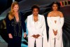 Hosts Amy Schumer, from left, Wanda Sykes, and Regina Hall appear on stage at the Oscars on Sunday, March 27, 2022, at the Dolby Theatre in Los Angeles. (AP Photo/Chris Pizzello)