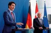 German Chancellor Olaf Scholz, right, and Canadian Prime Minister Justin Trudeau address a press conference at the Chancellery in Berlin after talks on Wednesday, March 9, 2022. The Prime Minister says that while the Russian invasion may be driving up energy prices, it is still providing the impetus to drive western economies towards developing greener energy sources. THE CANADIAN PRESS/Odd Andersen/Pool via AP