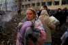 FILE - Mariana Vishegirskaya stands outside a maternity hospital that was damaged by shelling in Mariupol, Ukraine, Wednesday, March 9, 2022. Visheirskaya was taken to another nearby hospital where she gave birth the following day to a baby girl she named Veronika. “We were lying in wards when glass, frames, windows and walls flew apart,” she told AP, lying next to her newborn. 