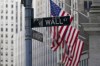 FILE - The Wall Street street sign is framed by the American flags flying outside the New York Stock exchange, Friday, Jan. 14, 2022, in the Financial District. Stocks are opening higher on Wall Street Tuesday, March 29, as another round of peace talks between Russia and Ukraine got underway. The S&P 500 rose 1.1% in the early going, as did the Dow Jones Industrial Average.(AP Photo/Mary Altaffer, File)