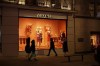 FILE - People walk past the temporarily closed Chanel shop on New Bond Street, during England's second coronavirus lockdown in London, on Nov. 25, 2020. French high fashion brand Chanel says it is stopping selling its clothes, perfumes and other luxury good to Russian customers abroad in a bold response to Moscow’s invasion of Ukraine. (AP Photo/Matt Dunham, File)