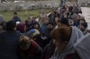 People receive food from a church in the town of Borodyanka, about 40 miles northwest of Kyiv, Ukraine, on Sunday, April 10, 2022. Several apartment buildings were destroyed during fighting between the Russian troops and the Ukrainian forces and the town is without electricity, water and heating. (AP Photo/Petros Giannakouris)