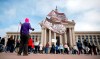 A person holds flags during the Bans Off Oklahoma Rally on the steps on Oklahoma state Capitol in Oklahoma City, Tuesday, April, 5, 2022. (Sarah Phipps/The Oklahoman via AP)