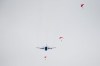 Parachuting soldiers are seen in the air as a CC130 Hercules transport aircraft flies overhead at Canadian Forces Base Trenton, in Trenton, Ont., Thursday, April 14, 2022. Canada's top military commander says his force is 