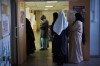 FILE - Women wait in line before voting for the first round of the presidential election at a polling station Sunday, April 10, 2022 in the Malpasse northern district of Marseille, southern France. French voters head to polls on Sunday in a runoff vote between centrist incumbent Emmanuel Macron and nationalist rival Marine Le Pen, wrapping up a campaign that experts have seen as unusually dominated by discriminatory discourse and proposals targeting immigration and Islam. (AP Photo/Daniel Cole, File)