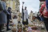 A Ukrainian priest blesses believers as they collect traditional cakes and painted eggs prepared for an Easter celebration in the in Lviv, Ukraine, Saturday, April 23, 2022. (AP Photo/Mykola Tys)