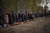 Worshipers stand next to their traditional cakes and painted eggs prepared for an Easter celebration during a religious service at a church in Bucha, on the outskirts of Kyiv, on Sunday, April 24, 2022. (AP Photo/Emilio Morenatti)