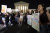 A crowd of people gather outside the Supreme Court, early Tuesday, May 3, 2022 in Washington. A draft opinion circulated among Supreme Court justices suggests that earlier this year a majority of them had thrown support behind overturning the 1973 case Roe v. Wade that legalized abortion nationwide, according to a report published Monday night in Politico. It's unclear if the draft represents the court's final word on the matter. The Associated Press could not immediately confirm the authenticity of the draft Politico posted, which if verified marks a shocking revelation of the high court's secretive deliberation process, particularly before a case is formally decided. (AP Photo/Alex Brandon)