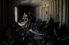 A Ukrainian serviceman and a worker carry the body of a Russian soldier into a refrigerated train in Kharkiv, Ukraine, Thursday, May 5, 2022. The bodies of more than 40 Russian soldiers who were found after battles around Kharkiv are being stored in the refrigerated car. (AP Photo/Felipe Dana)