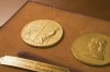 This undated photo shows the front and back sides of the medal awarded for the Pulitzer Prizes in New York. The Pulitzer Prizes are set Monday, May 9, 2022 to honor the best journalism from a tumultuous year that saw an insurrection, the frantic end of the United States' longest war and fallout from the ongoing coronavirus pandemic and catastrophic climate change. (The Pulitzer Prizes via AP)