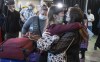 Nine year old Zoriana greets her sister, Sofiia, as her and their mother, Natalia, arrive from Ukraine in St. John's, Monday, May 9, 2022. Newfoundland and Labrador received its first plane load of refugees from Ukraine. THE CANADIAN PRESS/Greg Locke