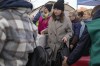 Refugees wait in line after fleeing the war from neighbouring Ukraine at the border crossing in Medyka, southeastern Poland, Friday, April 8, 2022. The federal government has created an online portal for Canadian businesses to donate to Ukrainians who need help to get set up in Canada after fleeing war in their country.THE CANADIAN PRESS/AP/Sergei Grits