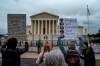 Abortion-rights protester Estephanie Ward uses a bullhorn to chant during a demonstration outside of the U.S. Supreme Court, Sunday, May 8, 2022, in Washington. The Liberal government says it is giving $3.5 million for two projects to help improve access to abortion services in Canada as the possible return of Roe v. Wade in the United States has brought renewed attention to the issue on both sides of the border.  (AP Photo/Gemunu Amarasinghe)