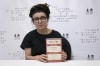 Polish writer and Nobel Prize winner for literature Olga Tokarczuk poses with her book 