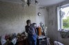 Roman Pryhodchenko cries inside his house damaged by multiple shelling in Kharkiv, Ukraine, Sunday, May 15, 2022. (AP Photo/Bernat Armangue)