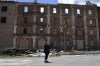 A woman called Albina, reacts in front of the destroyed Peter Dick's mill that had been damaged in Russian shelling in the village of Niu-York, Donetsk region, Ukraine, Monday, May 16, 2022. (AP Photo/Andriy Andriyenko)