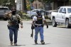 Police walk near Robb Elementary School following a shooting, Tuesday, May 24, 2022, in Uvalde, Texas. (AP Photo/Dario Lopez-Mills)