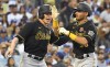 Pittsburgh Pirates' Jack Suwinski, left, congratulates Tucupita Marcano on his three-run home run while facing Los Angeles Dodgers starting pitcher Walker Buehler (21) during the second inning of a baseball game Monday, May 30, 2022, in Los Angeles. (AP Photo/John McCoy)