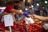 FILE - A customer pays for vegetables at the Maravillas market in Madrid, Thursday, May 12, 2022. Inflation hit a new record of 8.1% for the 19 countries that use the euro powered by surging energy costs boosted by the Russia-Ukraine war. The latest data Tuesday, May 31, 2022 from the European Union's statistics agency Eurostat showed that annual inflation in May surpassed the previous record of 7.4% reached in the previous two months. (AP Photo/Manu Fernandez, File)