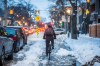 A cyclist makes their way down a slushy bike lane on Sherbrook Street on Monday. (Mikaela MacKenzie / Winnipeg Free Press)