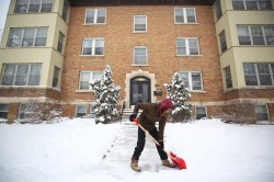 MIKE DEAL / WINNIPEG FREE PRESS
Florance Smith shovels the front steps of the apartment building she manages on McMillan Avenue on Thursday morning. (Mike Deal / Winnipeg Free Press)

220414 - Thursday, April 14, 2022