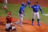 Toronto Blue Jays' Rowdy Tellez, center, is congratulated by Vladimir Guerrero Jr., right, after his two-run home run during the sixth inning of an exhibition baseball game against the Boston Red Sox, Tuesday, July 21, 2020, at Fenway Park in Boston. At left is Boston Red Sox catcher Christian Vazquez. (AP Photo/Charles Krupa)