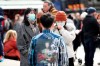 People wearing face masks stand in Piccadilly Circus, London, Saturday, March 7, 2020. A man in his early 80s has become the second person to die in the UK after testing positive for the coronavirus. (Yui Mok/PA via AP)