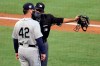Home plate umpire Alfonso Marquez, right, talks with Seattle Mariners manager Scott Servais about an infield hit by Los Angeles Angels' Mike Trout during the first inning of a baseball game in Anaheim, Calif., Saturday, Aug. 29, 2020. (AP Photo/Alex Gallardo)