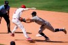 Los Angeles Angels' Andrelton Simmons, front left, is tagged out by Seattle Mariners third baseman Sam Haggerty in a rundown between first and second base during the seventh inning of a baseball game Sunday, Aug. 30, 2020, in Anaheim, Calif. Simmons drove in Albert Pujols with a single on the play. (AP Photo/Marcio Jose Sanchez)