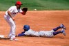 Los Angeles Dodgers' Mookie Betts, right, steals second base as Los Angeles Angels third baseman Anthony Rendon awaits the throw during the third inning of a baseball game Sunday, Aug. 16, 2020, in Anaheim, Calif. (AP Photo/Marcio Jose Sanchez)