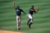 Seattle Mariners shortstop J.P. Crawford, left, and center fielder Kyle Lewis celebrate the team's win over the Los Angeles Angels in a baseball game in Anaheim, Calif., Monday, Aug. 31, 2020. (AP Photo/Kyusung Gong)