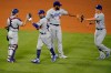 Los Angeles Dodgers' Austin Barnes, Mookie Betts, Kenley Jansen and Corey Seager, from left, celebrate the team's 6-5 win over the Los Angeles Angels in 10 innings in a baseball game Saturday, Aug. 15, 2020, in Anaheim, Calif. (AP Photo/Marcio Jose Sanchez)
