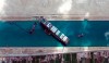 This satellite image from Maxar Technologies shows the cargo ship MV Ever Given stuck in the Suez Canal near Suez, Egypt, Sunday, March 28, 2021. Two additional tugboats sped Sunday to Egypt's Suez Canal to aid efforts to free a skyscraper-sized container ship wedged for days across the crucial waterway, even as major shippers increasingly divert their boats out of fear the vessel may take even longer to free. (©Maxar Technologies via AP)