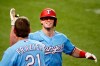 Texas Rangers' Nick Solak, right, is greeted at the dugout by Todd Frazier, left, after hitting a solo home run on a fly ball that the popped out of the mitt of Los Angeles Angels right fielder Jo Adell (not pictured) and went over the outfield wall during the fifth inning of a baseball game in Arlington, Texas, Sunday, Aug. 9, 2020. (AP Photo/Ray Carlin)