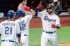Texas Rangers' Joey Gallo, right, is congratulated by Rougned Odor (12) and Todd Frazier (21) after hitting a two run home run off of Arizona Diamondbacks relief pitcher Andrew Chafin that scored Odor during the eighth inning of a baseball game Wednesday, July 29, 2020, in Arlington, Texas. Texas won 7-4. (AP Photo/Jeffrey McWhorter)