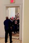 In this image made from video and provided by HuffPost, Capitol Police Officer Eugene Goodman speaks to an angry mob inside the U.S. Capitol in Washington on Jan. 6, 2021. One bright spot in all the chaos and anger from last week's mob siege at the U.S. Capitol was Goodman confronting a mob and retreating, risking his life to perhaps save the U.S. Senate. (Igor Bobic/HuffPost via AP)