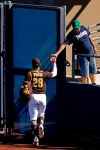 San Diego Padres' Tommy Pham greets a fan as he leaves the field during the fifth inning of a spring training baseball game against the San Francisco Giants Sunday, March 1, 2020, in Peoria, Ariz. (AP Photo/Charlie Riedel)