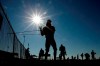 San Diego Padres pitcher Chris Paddack uses an elastic rope to stretch during baseball spring training Thursday, Feb. 13, 2020, in Peoria, Ariz. (AP Photo/Charlie Riedel)