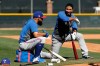 Texas Rangers' Rougned Odor, left, and Elvis Andrus talk while waiting to bat during spring training baseball practice Monday, Feb. 17, 2020, in Surprise, Ariz. (AP Photo/Charlie Riedel)